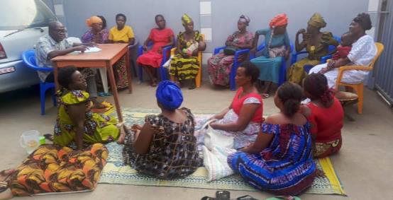 Pastor Boniface meeting with women in farming project